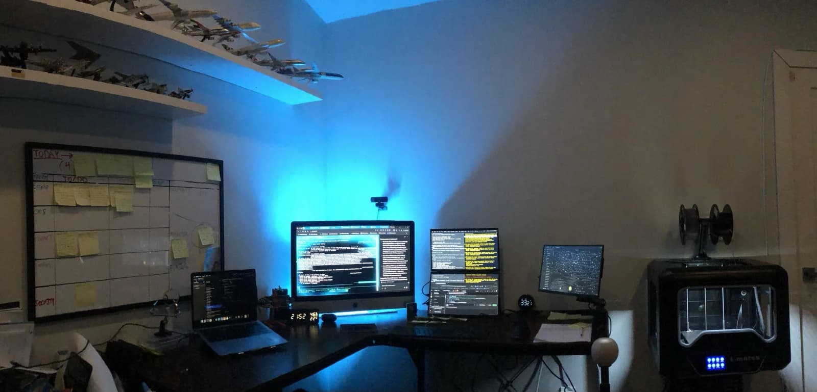 The desk: multiple monitors, an active session, the workflow in motion. The point is not the screens. The point is what they reveal about the work.